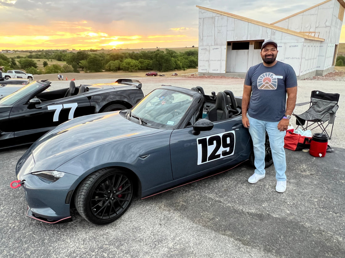 The First Ball, Roshan Vani’s white Mazda MX-5 Miata, driving during a track day.